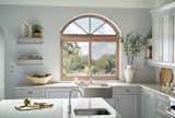 Essence Series horizontal sliding window with arch top above kitchen sink