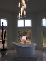 The Italian porcelain tile which carries right through and up the wall.  There’s a unique mosaic shower tower and all open concept when showering with 3 large windows which captures the outside.   