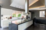 Elegant kitchen from Italy. High gloss cream lacquered colour with 12ft island. 6ft hood range 