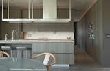 Kitchen, looking toward den/guest room. Full-height pocket doors convert powder room to ensuite bath. Poliform cabinets throughout add continuity and continuity and spaciousness to the 1930 sf house. 