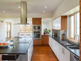 Picture, Wood, Glass, Kitchen, Granite, White, Wood, Medium Hardwood, Glass Tile, Ceiling, Refrigerator, Range Hood, Wall Oven, Cooktops, Undermount, Dishwasher, and Microwave Kitchen  Kitchen Medium Hardwood Picture Photos from Newtown Square