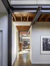 A dropped steel beam draws occupants into the main living area and defines a circulation corridor through the open spaces.