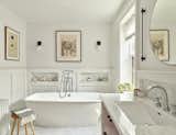 A new primary bath features custom cabinetry and a free-standing soaking tub,