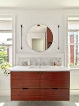 The new primary bath features a custom Claro Walnut vanity.