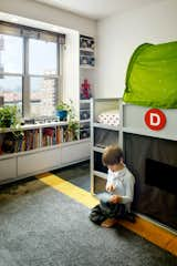 Dylan in his room with his train collection. 