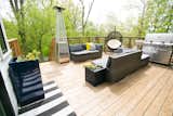 Elevated back deck, with concrete below accessible with barn doors for additional exterior storage