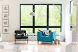Uncovered windows in the living room gain privacy with the surrounding trees