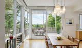 Dining Room, Chair, Medium Hardwood Floor, Table, and Pendant Lighting View to Buzzards Bay from dining room  Photo 7 of 21 in Konomore House by Charles Rose Architects