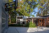 The garage building and the existing house with its bedroom addition frame the private backyard