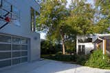 The garage building and the existing house with its bedroom addition frame the private backyard