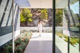 Trousdale Beverly Hills luxury home modern front entrance covered walkway & glass pivot door