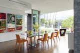 Summit House Beverly Hills luxury home bright modern dining room with floor to ceiling glass wall & artwork display