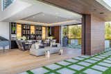 Bundy Drive Los Angeles luxury home piano bar & lounge with sliding glass pocket walls
