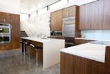 Kitchen, Engineered Quartz, Wood, Concrete, Ceiling, Glass Tile, Accent, Wall Oven, Refrigerator, Microwave, Cooktops, and Undermount Walnut Kitchen Cabinets by AvenueTwo, Caesarstone Countertops, Jenn-Air Appliances  Kitchen Accent Ceiling Glass Tile Photos from The Huff Residence