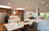 Kitchen with custom walnut cabinets by AvenueTwo. Caesarstone Countertops