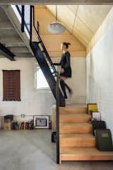Staircase, Wood Tread, and Metal Railing Stairs to Bedroom. Original exposed interior brick. Ships ladder to loft/bedroom. Original loft floor/ceiling. Polished concrete floor below.   Photo 12 of 13 in Blacksmith Shop by Design Platform
