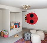 Kids Room, Playroom Room Type, Pre-Teen Age, Neutral Gender, Storage, Bench, and Carpet Floor Kids playroom with Charlie Harper wallpaper.   Photos from Forest Residence