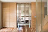 Staircase, Wood Tread, and Metal Railing Entry way with custom made entry closet built-in, hickory fins, and custom wall wraps by Platform Workshop. Perforated metal screens by Gulley Metal.   Photo 2 of 20 in Forest Residence by Design Platform