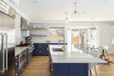 Kitchen area. White oak floating shelves. Mixture of brass and stainless steel. Thermador appliances. Caesarstone countertops. 