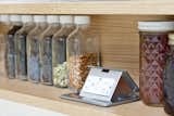Kitchen, Engineered Quartz Counter, and Wood Cabinet Detail shot of custom spice rack by AvenueTwo:Design with pop up outlets.   Photo 8 of 8 in Pletcher Kitchen by Design Platform