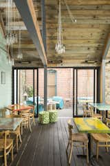 View from restaurant into expansion. The indoor/outdoor feel is amazing. redwood decking used on the floor to keep the feeling of being outside. 