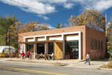 Exterior renovation included converting old garage overhead doors to new storefront and expanding indoor/outdoor dining onto the street. Located adjacent to a community garden. 