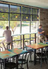 Dining area and eat in counter. Custom painted tables by Platform Workshop. 