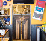 Custom made kitchen doors by Design Platform. Reclaimed lath, cut and stained inside a steel angle frame. 