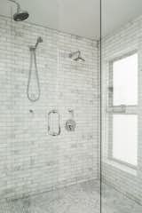 Interior of the master shower. Clean and cool marble tile in subway and penny tile layouts. Natural light was provided through the windows that were frosted with 3M film for privacy. 