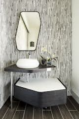 Powder room vanity from Porcelanosa with floor to ceiling tile. 