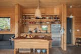 The kitchen features a handcrafted wooden island and cabinetry. 