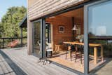 Large sliding doors extend the living space to the exterior.   Photo 14 of 19 in Cabin on the Vistula by Nate Cook Photography