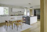 Kitchen, Refrigerator, Tile Counter, Porcelain Tile Backsplashe, Light Hardwood Floor, Cooktops, Recessed Lighting, Undermount Sink, and White Cabinet  Photo 12 of 20 in Courtyard Contemporary by LDa  Architecture & Interiors