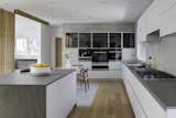 Kitchen, White Cabinet, Recessed Lighting, Wall Oven, Porcelain Tile Backsplashe, Stone Counter, Cooktops, Refrigerator, Light Hardwood Floor, and Undermount Sink  Photo 13 of 20 in Courtyard Contemporary by LDa  Architecture & Interiors
