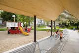 Shade structure adjacent to park playground.