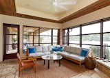 Screened porch with custom abaca rug, vintage leather sling chair, client's own quartz coffee table and custom sectional with Perennials and Holland and Sherry fabrics.