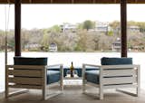 Pair of Aegean aluminum collection lounge chairs and ottoman from Restoration Hardware paired with side table from CB2 over looking Lake Austin.