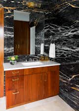 Black and gold Zebrino marble clad walls, Egyptian travertine floor tiles, Custom walnut vanity with Waterworks Atlas fixture, Pigeon & Poodle accessories, Rejuvanation's Yeon double sconce.