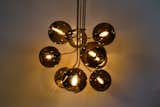 This grand pendant named "Tree of Light", comprised of 9 mouth blown glass spheres. Suspended via custom made brass branches. Also available in fewer branches and as a floor lamp.
  Photo 4 of 6 in Tree of Light