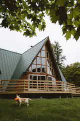 Upper-Scale Peninsula:

I had the great pleasure of spending nine days at this beast of a cabin in Michigan's Upper Peninsula with some friends last spring. Deep in the backwoods, the structure sits atop a small hill overlooking a private lake with row boats and all. The exterior shows itself as an A-frame but inside you'll find it's anything but - spacious with five bedrooms, a kitchen and two common areas. And I can't forget our furry friend, Georgia, master of the fluorescent hunting cap.