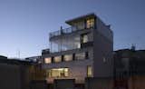 Theis and Khan remained mindful of the building’s aesthetics within the greater context of the neighborhood. Within the concrete frame, the highly insulated brick walls make direct reference to the surrounding Shoredich building types. The base of the building is a dark engineering brick, commonly used at ground floor level in this area to provide a strong damage-proof finish. The upper stories are designed to incorporate a yellow Danish brick that reflects the surrounding yellow London stock brick. In contrast to the rough texture of the brickwork, the windows are framed by a dark grey metal to correspond to the adjacent industrial buildings.