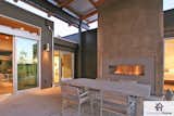 A nearly seamless transition from indoor to outdoor living spaces featuring the stainless steel J Series outdoor fireplace by European Home.