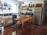 Open kitchen used local ash for the live edge open shelves, vintage workbench island and Ikea cabinets