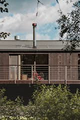 Exterior, Cabin Building Type, Mansard RoofLine, Shed Building Type, Prefab Building Type, Metal Roof Material, Shed RoofLine, and Wood Siding Material Powerful cantilever arms of the upper part create a visual effect of the construction being detached from the ground  Photo 12 of 30 in Modular house on the slope by Ivan Ovchinnikov