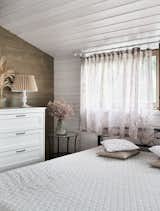 Bedroom, Shelves, Ceiling Lighting, Bed, Light Hardwood Floor, and Medium Hardwood Floor The interior is designed in a light rustic style  Photo 18 of 30 in Modular house on the slope by Ivan Ovchinnikov