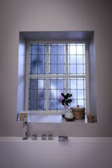 The master bathroom with a beautiful stained glass window