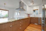 The kitchen features quartzite counter tops and custom cabinets by Semihandmade
