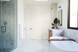 Bath Room, Marble Counter, Wall Lighting, Freestanding Tub, Undermount Sink, Marble Floor, Stone Slab Wall, and Enclosed Shower Primary Bathroom  Photo 13 of 20 in The Strand Residence by Jette Creative