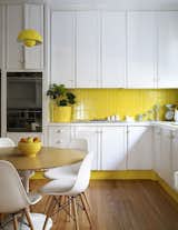 This sunny yellow kitchen successfully mixes vintage charm with mid-century furniture.
