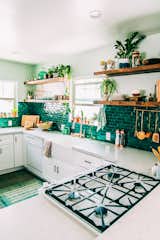 These green tiles are a perfect backdrop for the wealth of potted plants lining the shelves and window sills in this L.A. artist's kitchen.&nbsp;